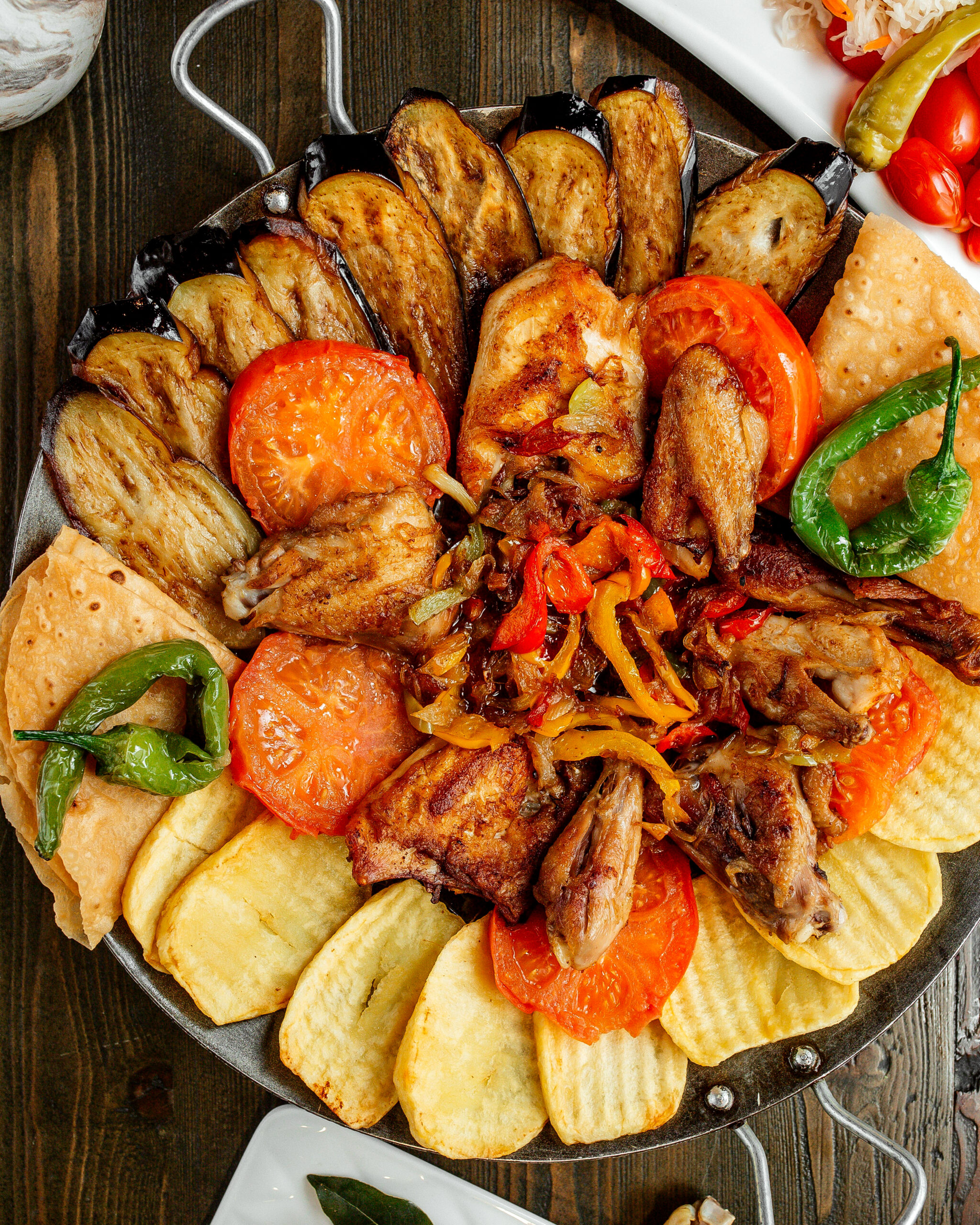 fried chicken with grilled potatoes eggplants tomatoes and peppers