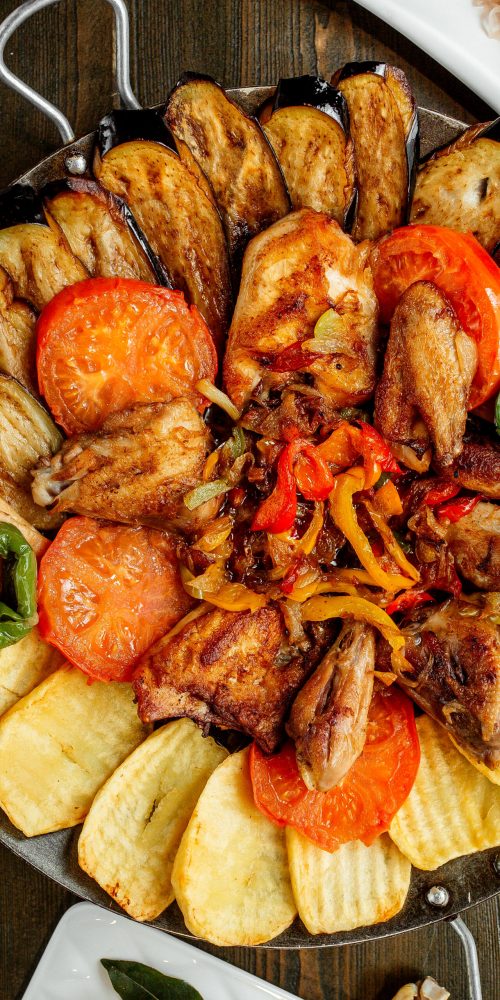 fried chicken with grilled potatoes eggplants tomatoes and peppers
